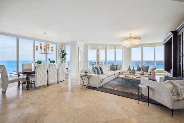 living area with a water view, expansive windows, and a notable chandelier