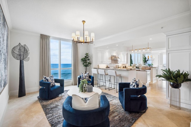 living room with a chandelier, a water view, crown molding, and baseboards