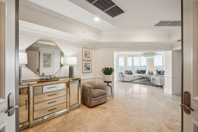 living area with ornamental molding, visible vents, and a notable chandelier