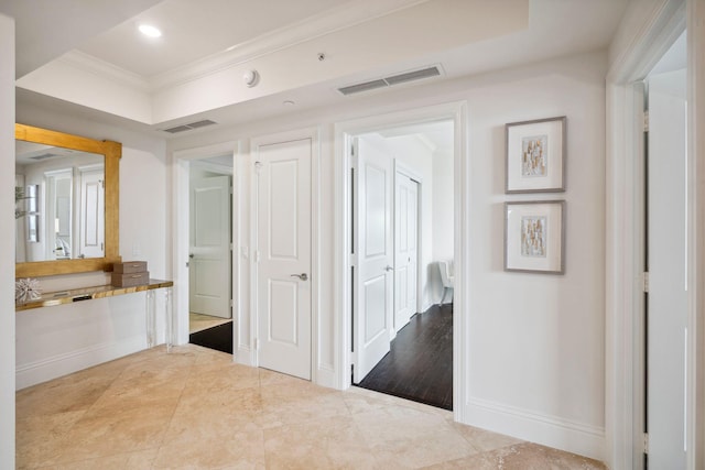 hall featuring ornamental molding, recessed lighting, visible vents, and baseboards