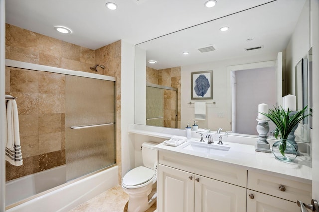 full bath with visible vents, shower / bath combination with glass door, vanity, and toilet