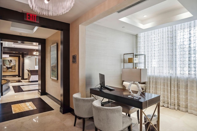 office space with marble finish floor, visible vents, a tray ceiling, and baseboards