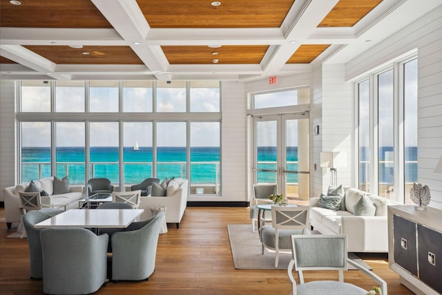 sunroom with french doors, a water view, coffered ceiling, and wooden ceiling