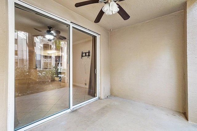 property entrance with a patio area and ceiling fan