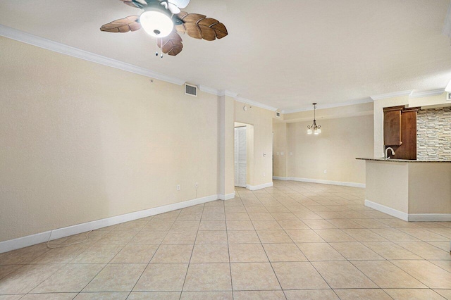 tiled spare room featuring crown molding, sink, and ceiling fan with notable chandelier