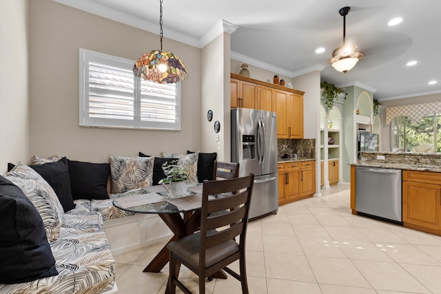 kitchen featuring light tile patterned flooring, tasteful backsplash, light stone counters, pendant lighting, and stainless steel appliances