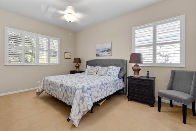 bedroom featuring ceiling fan and light carpet