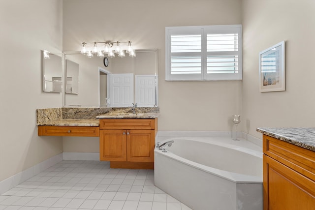 bathroom featuring vanity, tile patterned floors, and a tub