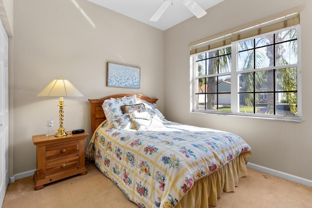 bedroom featuring light carpet and ceiling fan