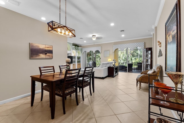 dining space featuring crown molding and light tile patterned floors