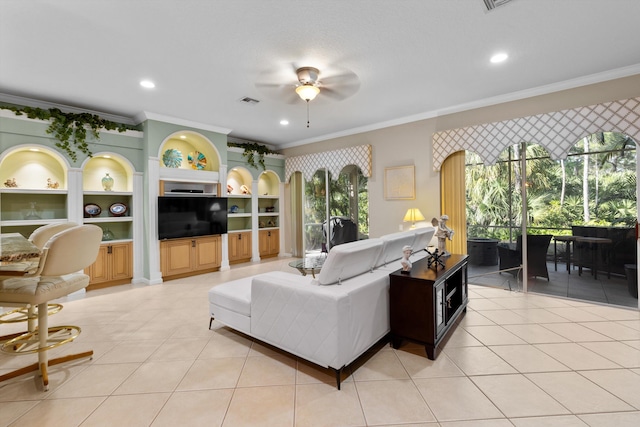 living room featuring crown molding, ceiling fan, built in features, and light tile patterned floors