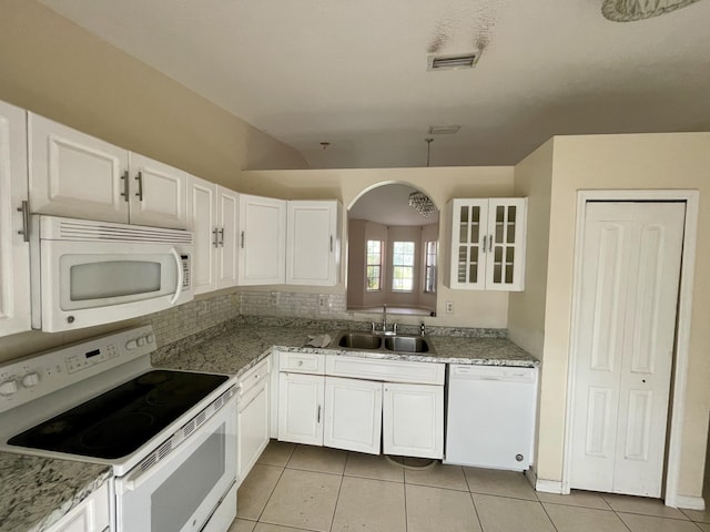 kitchen featuring sink, light stone counters, light tile patterned floors, white appliances, and white cabinets