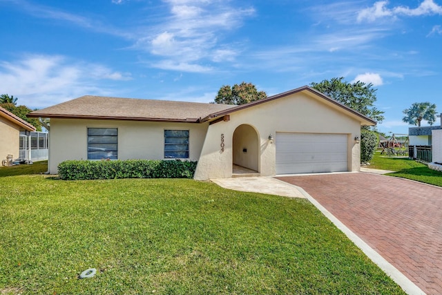 single story home featuring a garage and a front yard