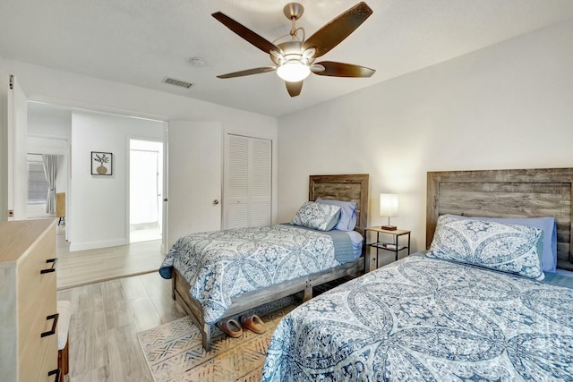 bedroom featuring a closet, ceiling fan, and light wood-type flooring