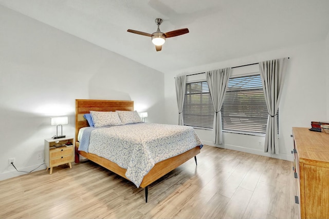 bedroom featuring vaulted ceiling, light hardwood / wood-style floors, and ceiling fan