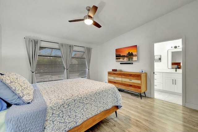 bedroom with ensuite bath, light hardwood / wood-style flooring, and ceiling fan