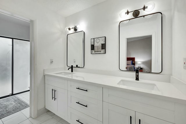 bathroom with vanity and a textured ceiling