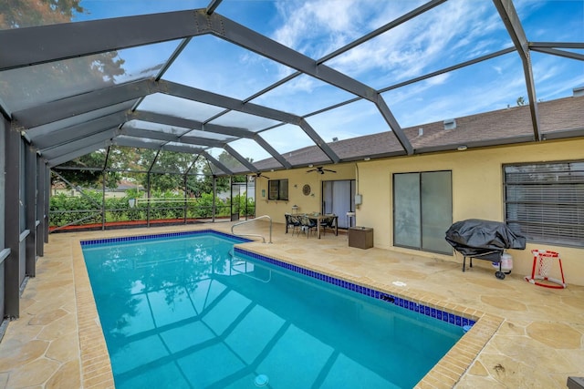 view of swimming pool with area for grilling, glass enclosure, and a patio area