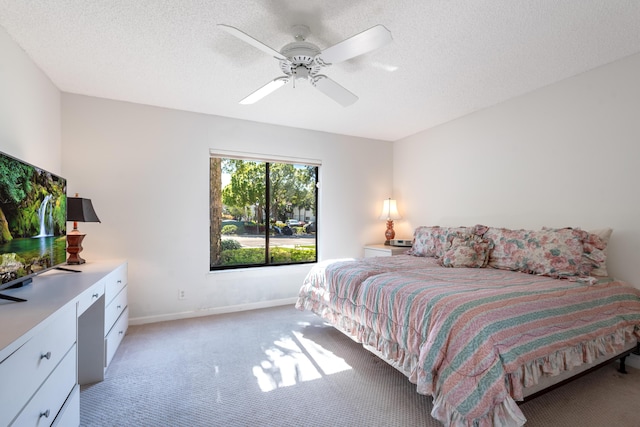 bedroom featuring a textured ceiling, ceiling fan, and carpet flooring