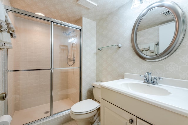 bathroom with an enclosed shower, vanity, and toilet