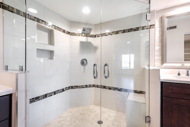 bathroom featuring vanity and an enclosed shower