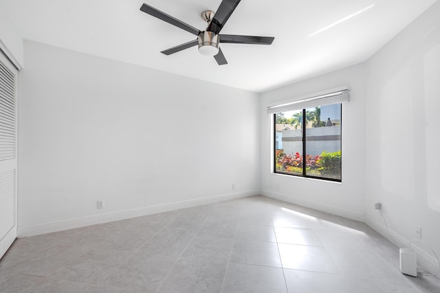 spare room with light tile patterned floors and ceiling fan