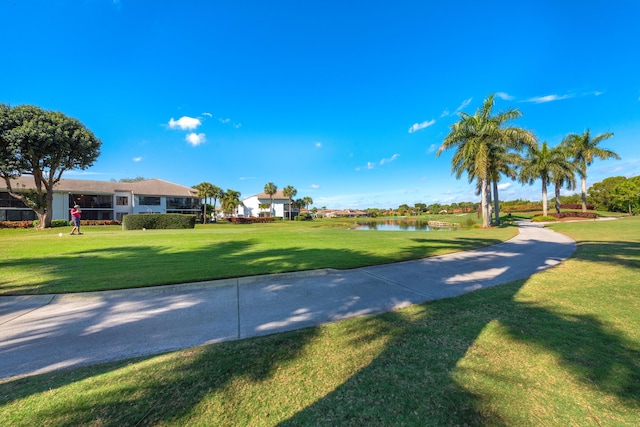 view of community featuring a lawn and a water view