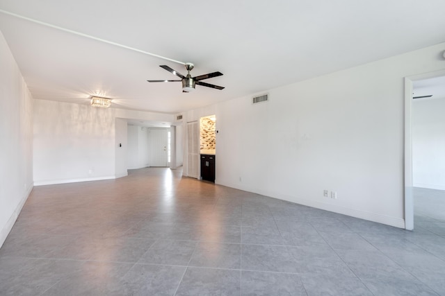 unfurnished living room with ceiling fan