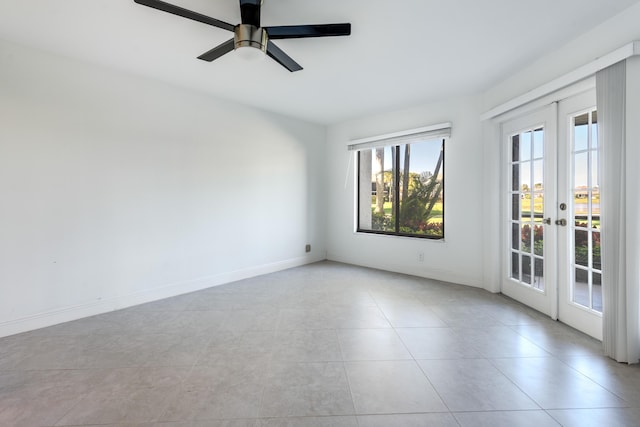 spare room with light tile patterned floors, ceiling fan, and french doors