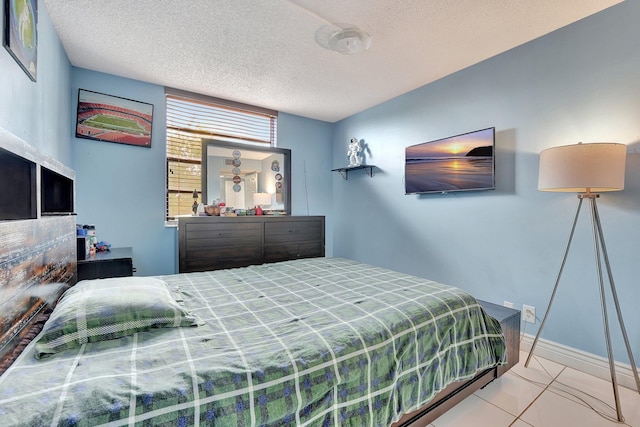 bedroom featuring light tile patterned flooring and a textured ceiling