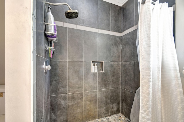 bathroom with tiled shower