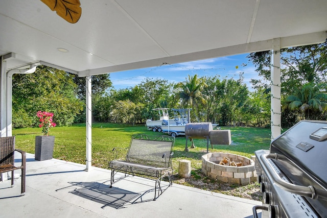 view of patio with a fire pit and area for grilling