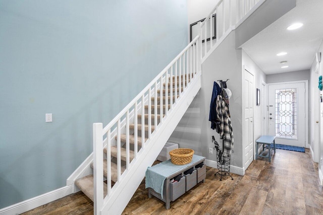 staircase with wood-type flooring