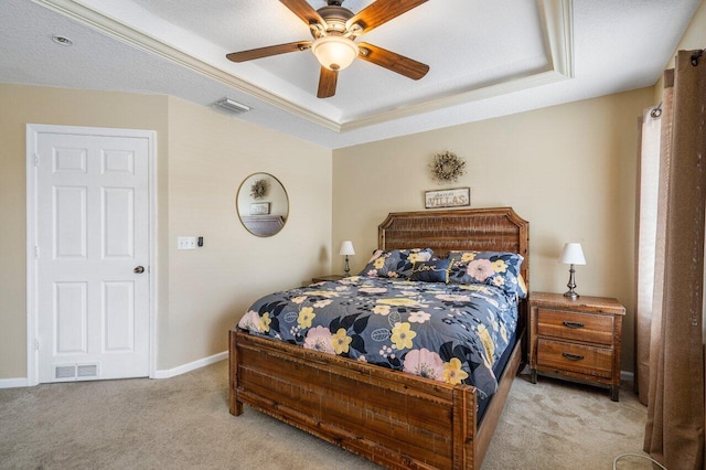 carpeted bedroom featuring ceiling fan, a raised ceiling, and a textured ceiling