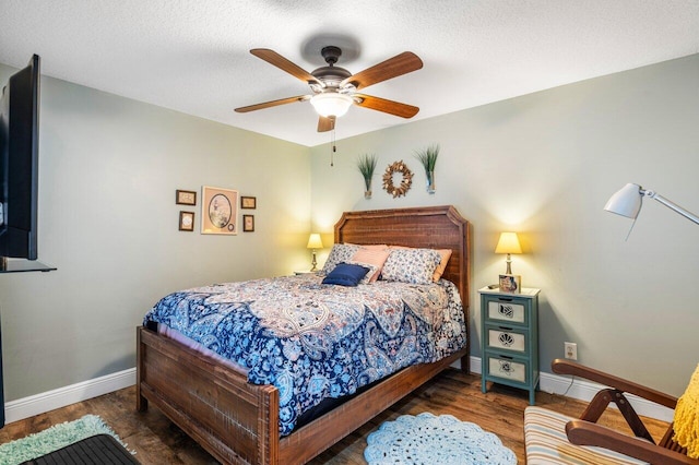 bedroom with dark hardwood / wood-style flooring and ceiling fan