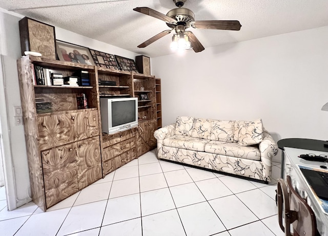 tiled living room featuring ceiling fan and a textured ceiling