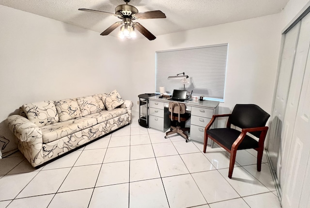 office space featuring light tile patterned floors, a textured ceiling, and ceiling fan