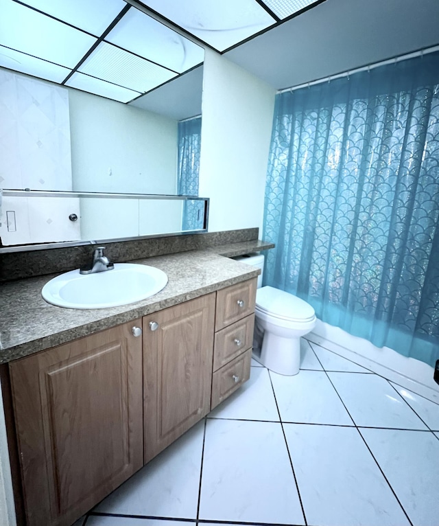 full bathroom featuring tile patterned floors, vanity, toilet, and shower / tub combo