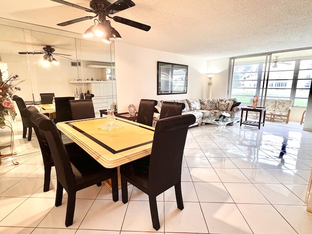 dining room featuring expansive windows, tile patterned flooring, and a textured ceiling