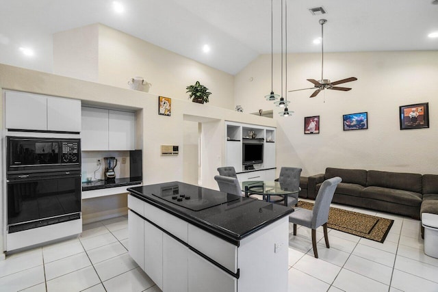 kitchen with hanging light fixtures, white cabinetry, light tile patterned floors, and black appliances