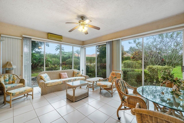 sunroom with a wall mounted air conditioner, a wealth of natural light, and ceiling fan