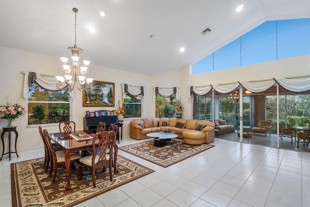 dining room featuring lofted ceiling, light tile patterned floors, and an inviting chandelier