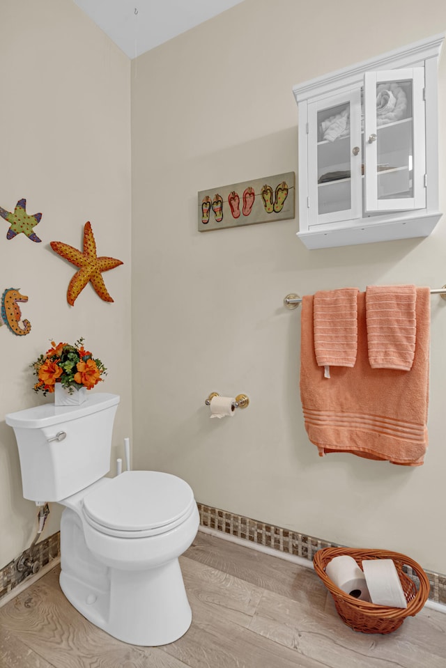 bathroom with wood-type flooring and toilet