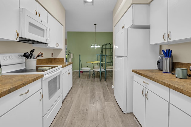 kitchen with white cabinetry, light wood-type flooring, a notable chandelier, pendant lighting, and white appliances