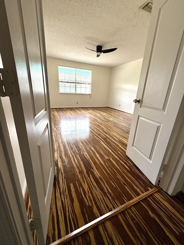9189 Boca Gardens Cir Unit D, Boca Raton, FL 33496 - unfurnished bedroom featuring wood finished floors, a textured ceiling, and a ceiling fan