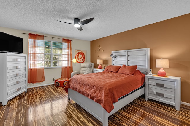 bedroom with a textured ceiling, dark wood-type flooring, and ceiling fan