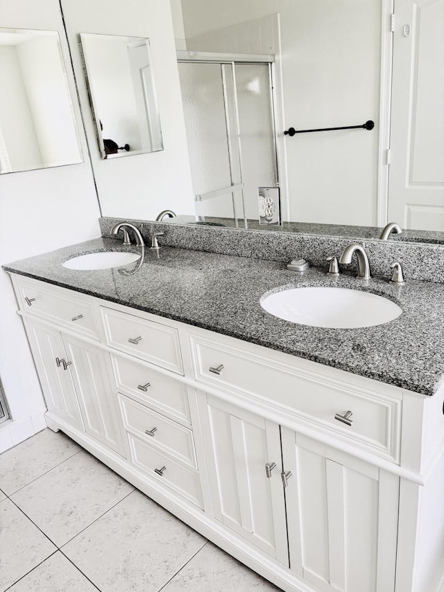 9189 Boca Gardens Cir Unit D, Boca Raton, FL 33496 - bathroom featuring double vanity, tile patterned floors, and a stall shower