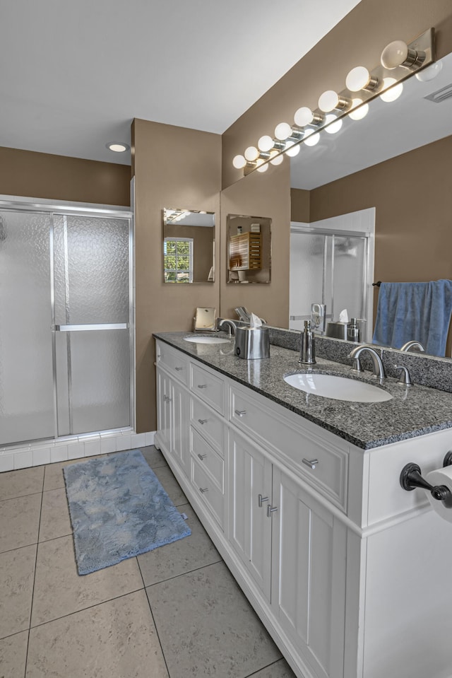 bathroom with vanity, an enclosed shower, and tile patterned floors