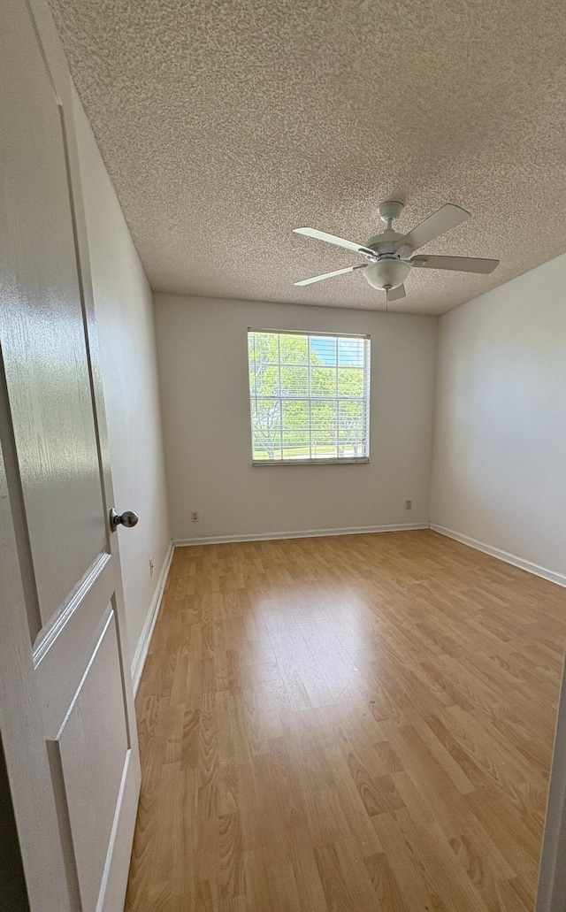 9189 Boca Gardens Cir Unit D, Boca Raton, FL 33496 - unfurnished room featuring a textured ceiling, light wood finished floors, and ceiling fan