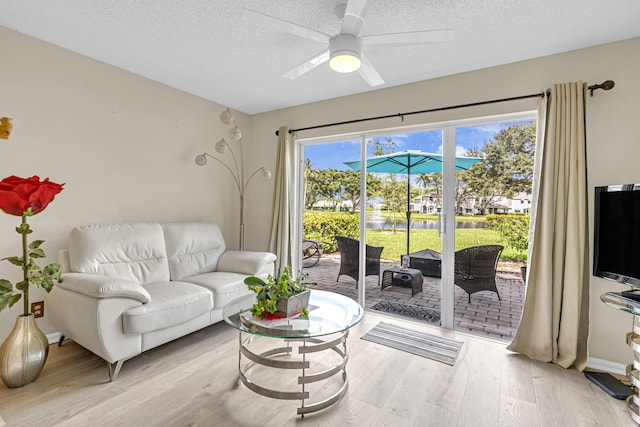 9189 Boca Gardens Cir Unit D, Boca Raton, FL 33496 - living room featuring light wood-type flooring, a textured ceiling, and ceiling fan